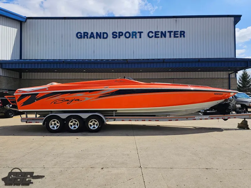 Slide: The Image of 2007 Baja 35 Outlaw speedboat in vibrant orange at Grand Sport Center. - 2