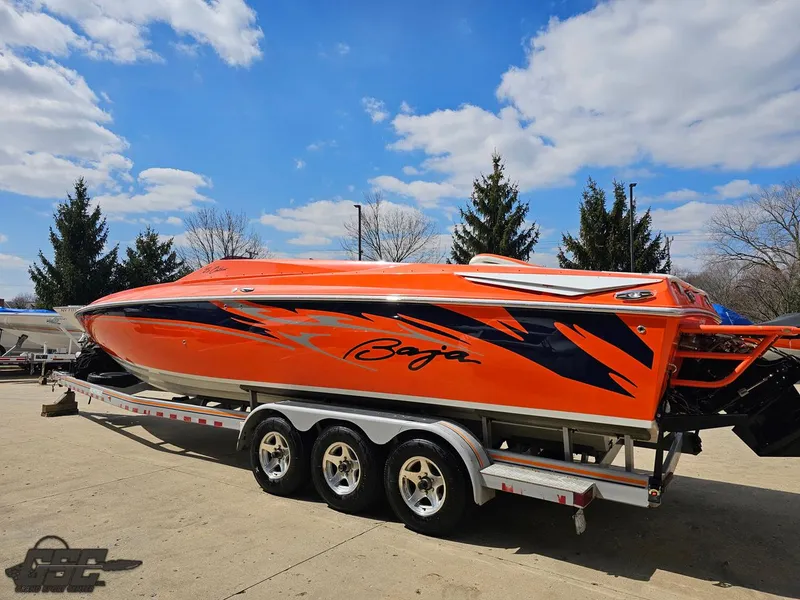 Slide: The Image of 2007 Baja 35 Outlaw speedboat in vibrant orange with bold graphics on a trailer. - 28
