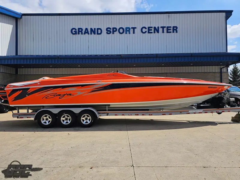 Slide: The Image of 2007 Baja 35 Outlaw boat in vibrant orange at Grand Sport Center. - 3