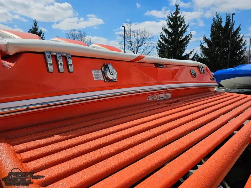 Slide: The Image of 2007 Baja 35 Outlaw boat with orange deck, under a blue sky. - 32