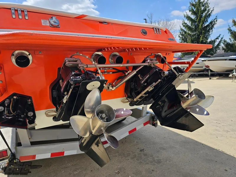 Slide: The Image of 2007 Baja 35 Outlaw boat with dual propellers and vibrant orange exterior. - 33