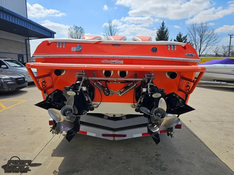 Slide: The Image of 2007 Baja 35 Outlaw boat, rear view with dual propellers, parked outdoors. - 34