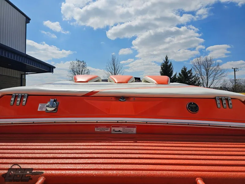 Slide: The Image of 2007 Baja 35 Outlaw boat with vibrant orange detailing under a blue sky. - 38