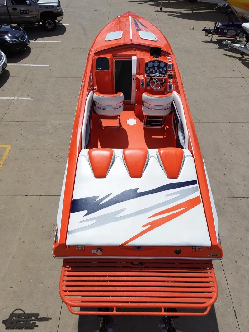 Slide: The Image of 2007 Baja 35 Outlaw speedboat with vibrant orange and white design, viewed from above. - 39