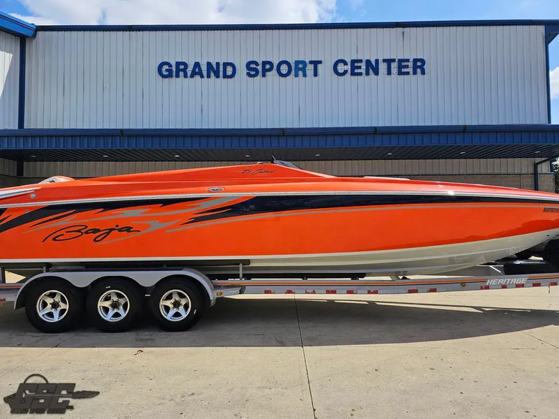 Slide: The Image of 2007 Baja 35 Outlaw boat in vibrant orange at Grand Sport Center. - 4