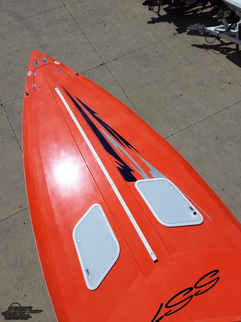 Slide: The Image of 2007 Baja 35 Outlaw boat with vibrant orange deck and sleek design. - 40