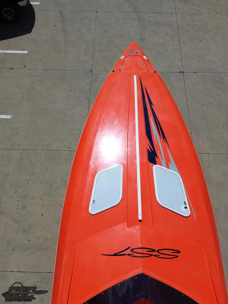 Slide: The Image of 2007 Baja 35 Outlaw boat with vibrant orange deck and sleek design. - 41