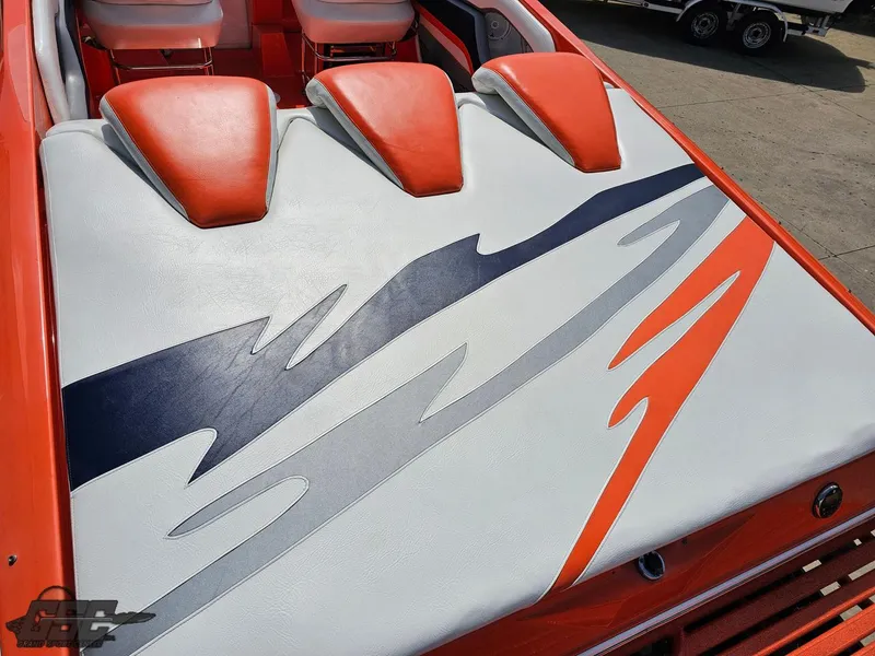 Slide: The Image of 2007 Baja 35 Outlaw boat with vibrant orange and white upholstery design. - 43