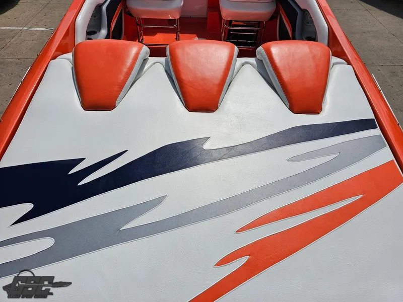 Slide: The Image of 2007 Baja 35 Outlaw boat interior with vibrant orange and white upholstery design. - 45
