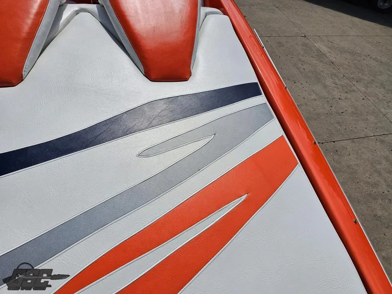 Slide: The Image of 2007 Baja 35 Outlaw boat seat with orange, gray, and navy design. - 48