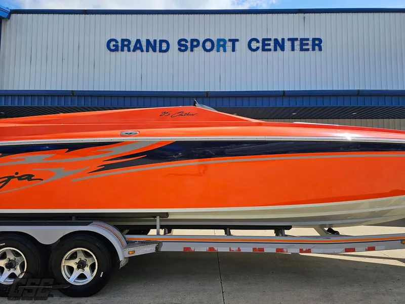 Slide: The Image of 2007 Baja 35 Outlaw boat in vibrant orange at Grand Sport Center. - 5