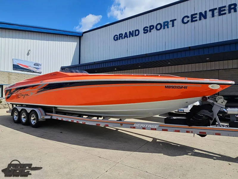 Slide: The Image of 2007 Baja 35 Outlaw boat in vibrant orange on a trailer at Grand Sport Center. - 7