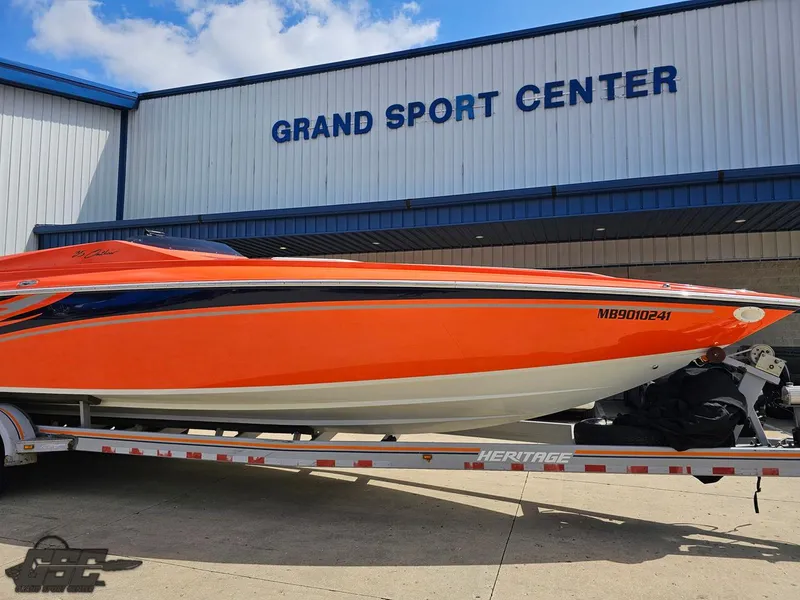 Slide: The Image of 2007 Baja 35 Outlaw boat in vibrant orange at Grand Sport Center. - 8