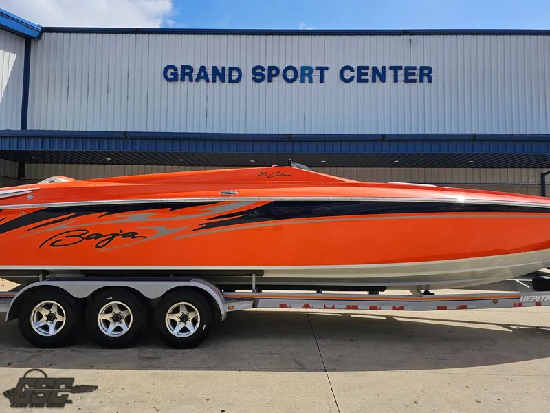 Slide: The Image of 2007 Baja 35 Outlaw boat in vibrant orange at Grand Sport Center. - 9