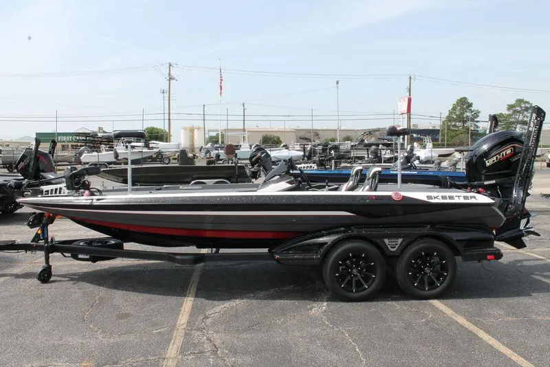 Slide: The Image of 2026 Skeeter FXR 21 FLEX boat on trailer, parked outdoors. - 10