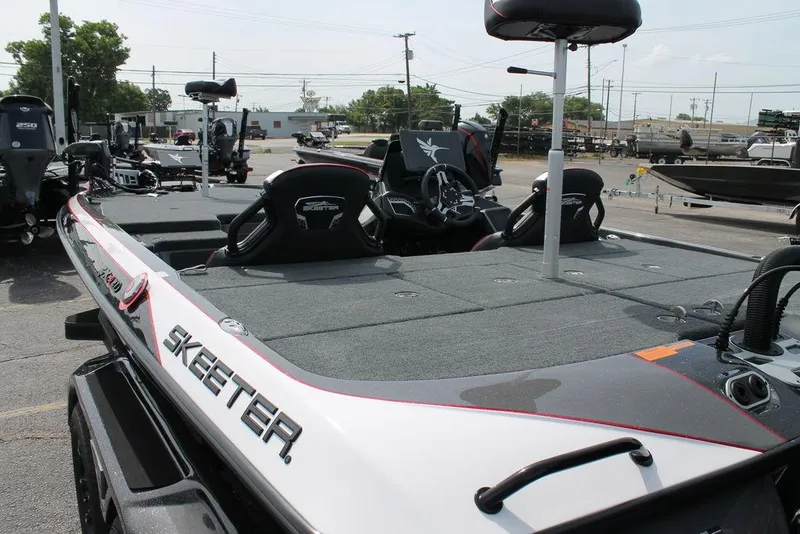 Slide: The Image of 2026 Skeeter FXR 21 FLEX boat with spacious deck and seating, parked outdoors. - 3