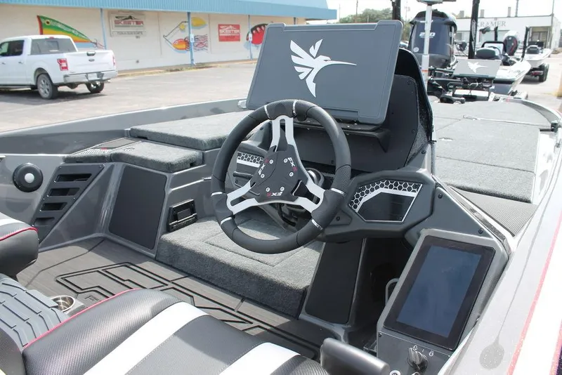 Slide: The Image of 2026 Skeeter FXR 21 FLEX boat interior with modern steering and digital display. - 4