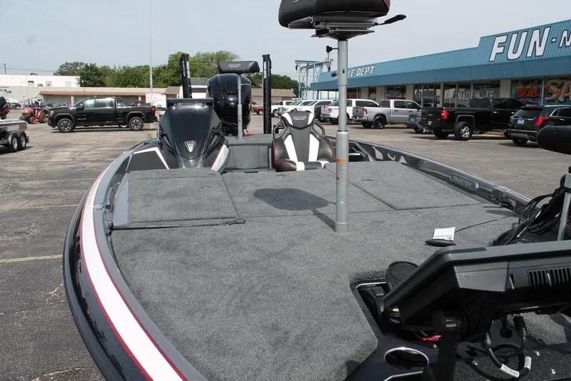 Slide: The Image of 2026 Skeeter FXR 21 FLEX boat with spacious deck in a dealership lot. - 5