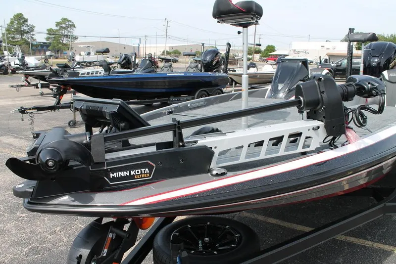 Slide: The Image of 2026 Skeeter FXR 21 FLEX boat with Minn Kota Ultrex motor in a parking lot. - 9