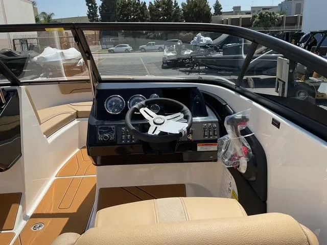 Slide: The Image of 2025 Bayliner V20i boat interior with modern dashboard and steering wheel. - 12