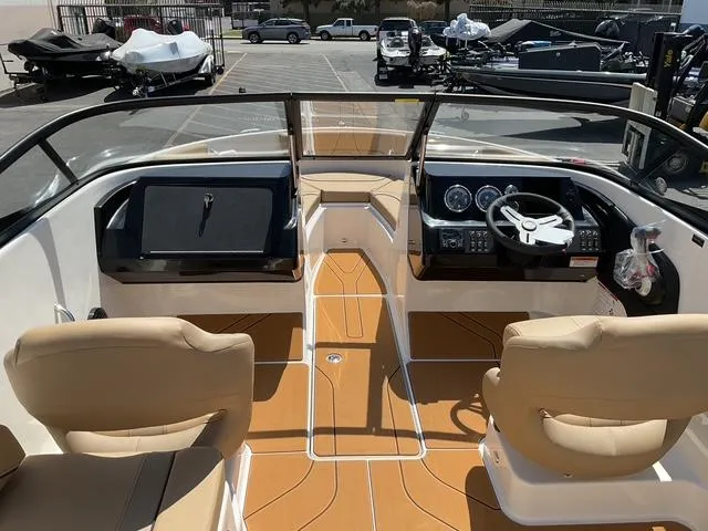 Slide: The Image of 2025 Bayliner V20i boat interior with tan seats and modern dashboard. - 13