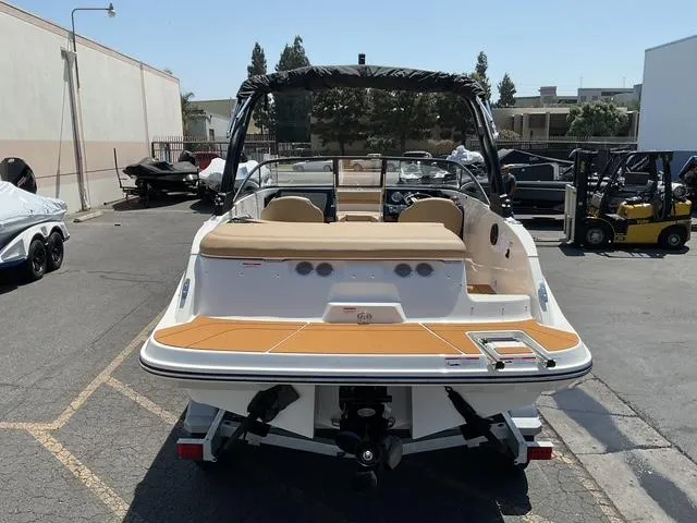 Slide: The Image of 2025 Bayliner V20i boat, rear view, parked outdoors on a trailer. - 15