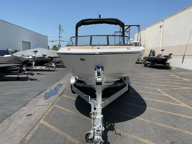 Slide: The Image of 2025 Bayliner V20i boat on trailer in parking lot, front view. - 7