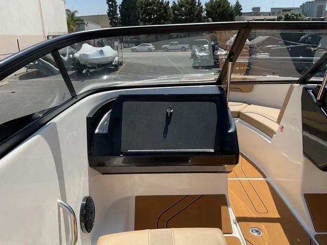 Slide: The Image of 2025 Bayliner V20i boat interior with tan seating and sleek dashboard design. - 8