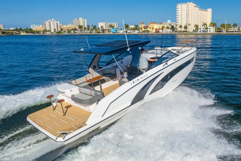Slide: The Image of 2025 Hanover 377 Outboard boat cruising on water near city skyline. - 1