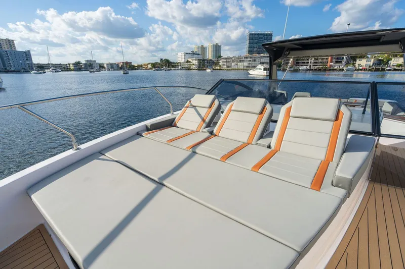 Slide: The Image of 2025 Hanover 377 Outboard boat with luxurious sun loungers on deck, docked by the waterfront. - 6