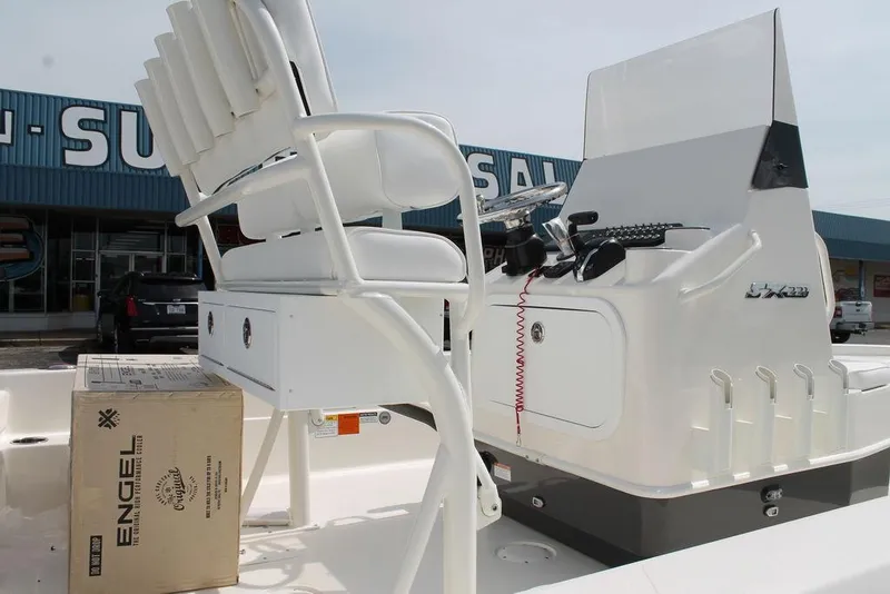 Slide: The Image of 2026 Skeeter SX221 boat interior with helm, seating, and Engel cooler box. - 1