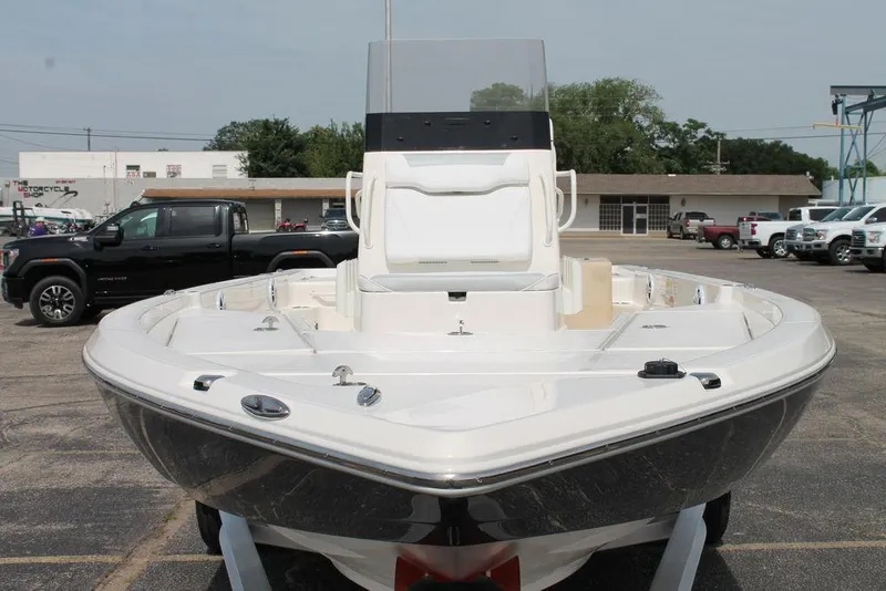 Slide: The Image of 2026 Skeeter SX221 boat displayed in a parking lot, showcasing its sleek design and spacious deck. - 2