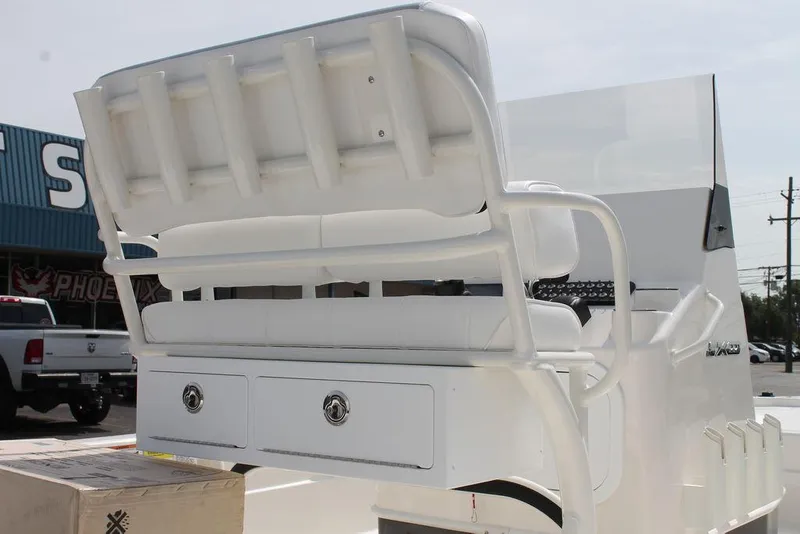 Slide: The Image of 2026 Skeeter SX221 boat with white seating and storage drawers, outdoor setting. - 3
