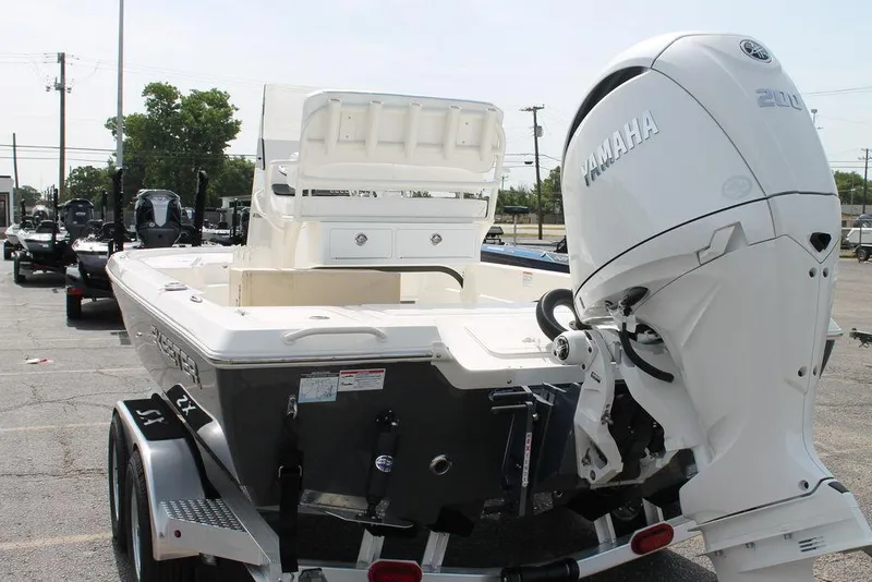 Slide: The Image of 2026 Skeeter SX221 boat with Yamaha engine, parked on a trailer in a lot. - 4