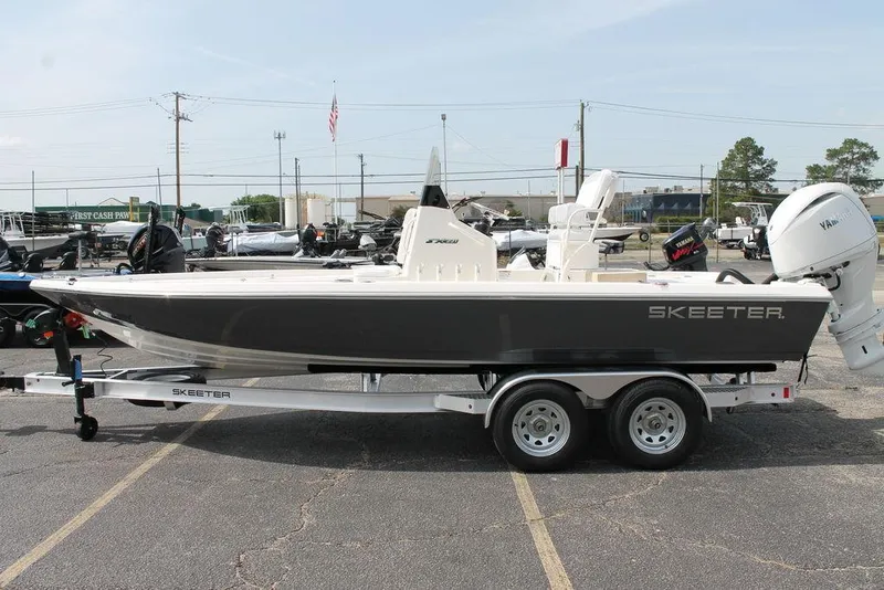 Slide: The Image of 2026 Skeeter SX221 boat on trailer, parked in a lot, side view. - 5