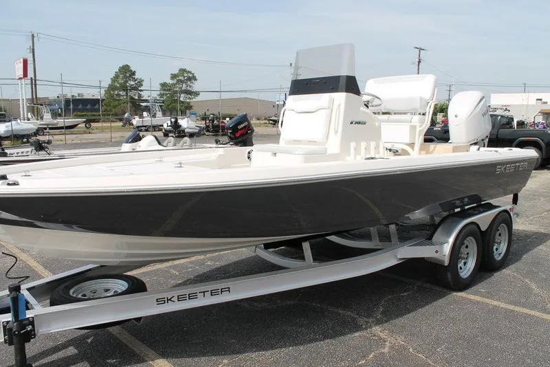 Slide: The Image of 2026 Skeeter SX221 boat on trailer in parking lot. - 8
