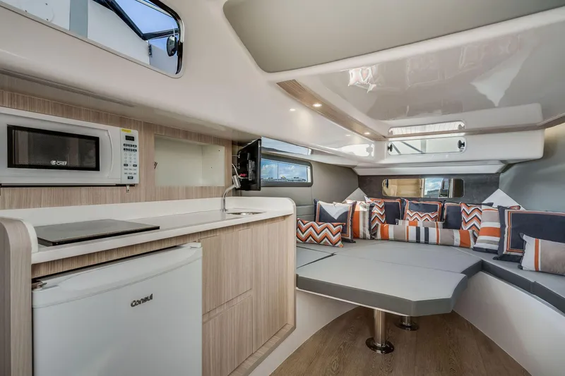 Slide: The Image of Interior of 2025 Hanover 377 Outboard boat with modern kitchen and seating area. - 13