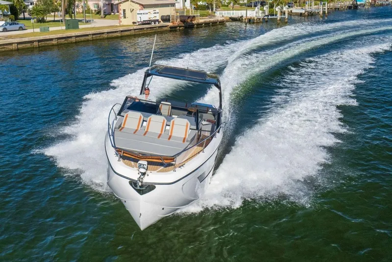 Slide: The Image of 2025 Hanover 377 Outboard cruising on a sunny day in a scenic waterway. - 4