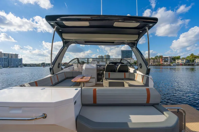 Slide: The Image of 2025 Hanover 377 Outboard boat with spacious deck and modern design on a sunny day. - 7