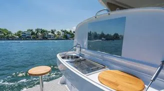 Slide: The Image of 2025 Hanover 375 Inboard yacht with outdoor kitchen, cruising on a sunny day. - 11