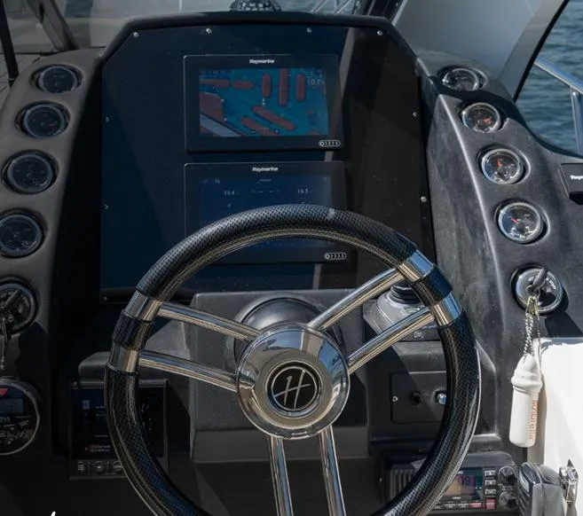 Slide: The Image of Steering console of 2025 Hanover 375 Inboard boat with modern navigation displays. - 12