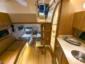 Slide: The Image of Luxurious interior of 2025 Hanover 375 Inboard yacht with modern amenities and wooden finishes. - 14
