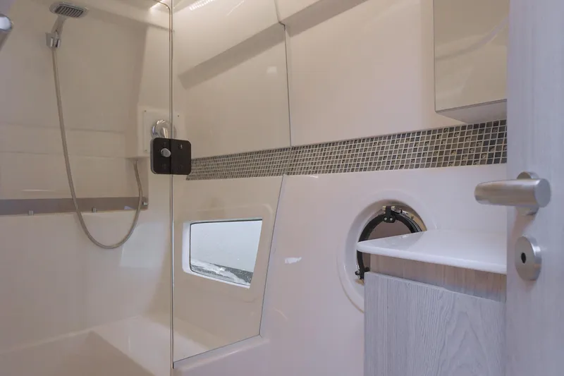 Slide: The Image of Modern bathroom interior in 2025 Hanover 375 Outboard boat, featuring sleek design and glass shower. - 18