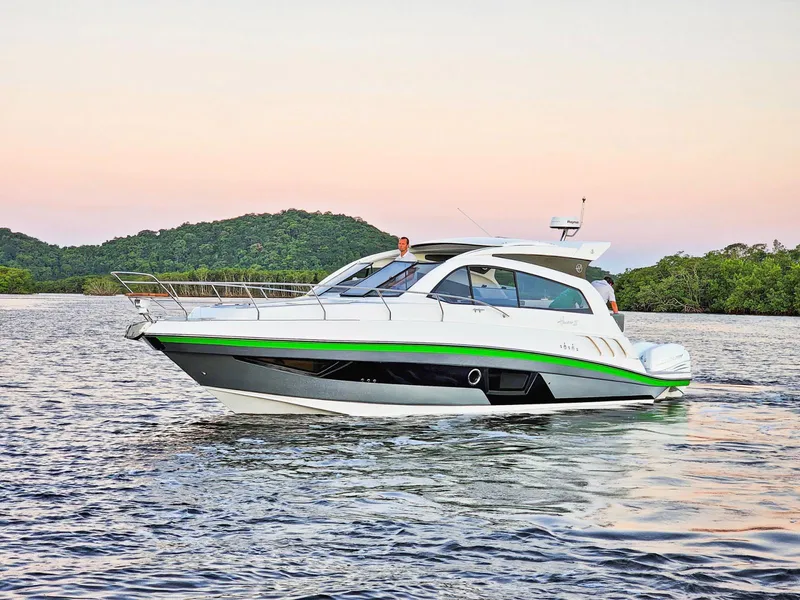 Slide: The Image of 2025 Hanover 375 Outboard boat cruising on a serene lake at sunset. - 1