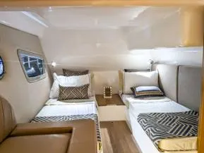 Slide: The Image of 2025 Hanover 375 Outboard cabin interior with twin beds and modern decor. - 12