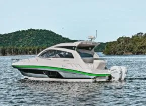 Slide: The Image of 2025 Hanover 375 Outboard boat on water with scenic forested background. - 3
