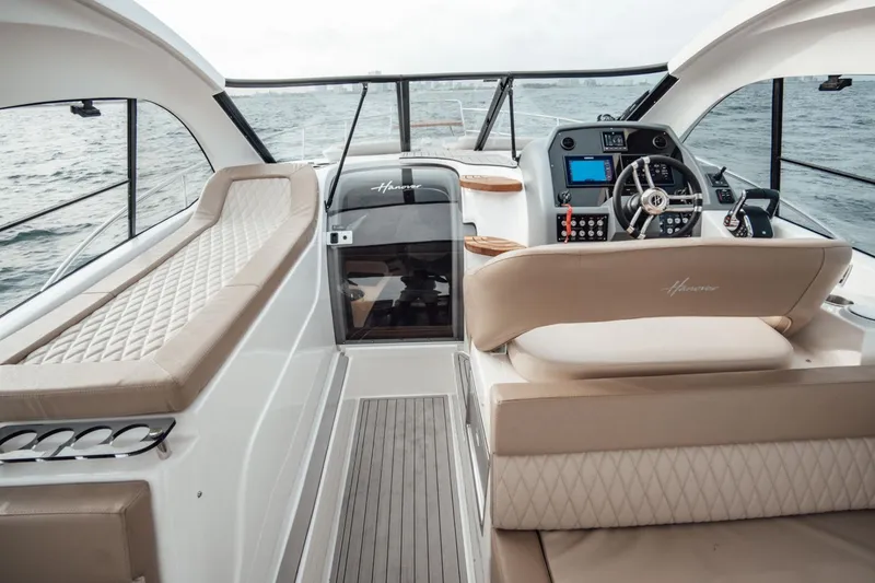 Slide: The Image of Interior view of 2025 Hanover 375 Outboard boat with luxurious seating and modern dashboard. - 6