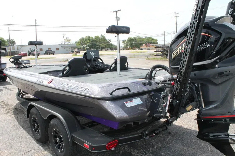 Slide: The Image of 2026 Skeeter ZXE21 boat with Yamaha engine, parked on a trailer in an outdoor setting. - 3