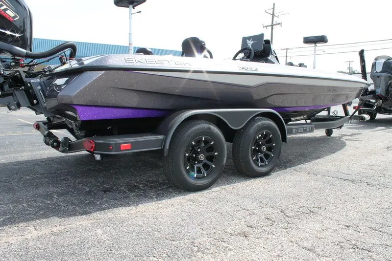 Slide: The Image of 2026 Skeeter ZXE21 boat on trailer, featuring sleek design and dual axles. - 4