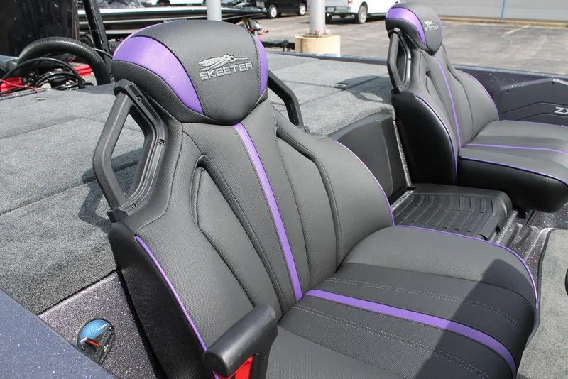 Slide: The Image of 2026 Skeeter ZXE21 boat with spacious deck and modern seating at a dealership. - 9